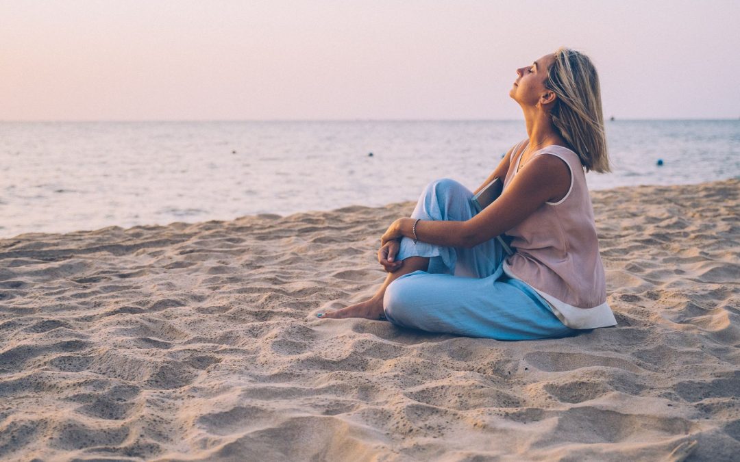 A Blonde Woman Relaxing on the Beach