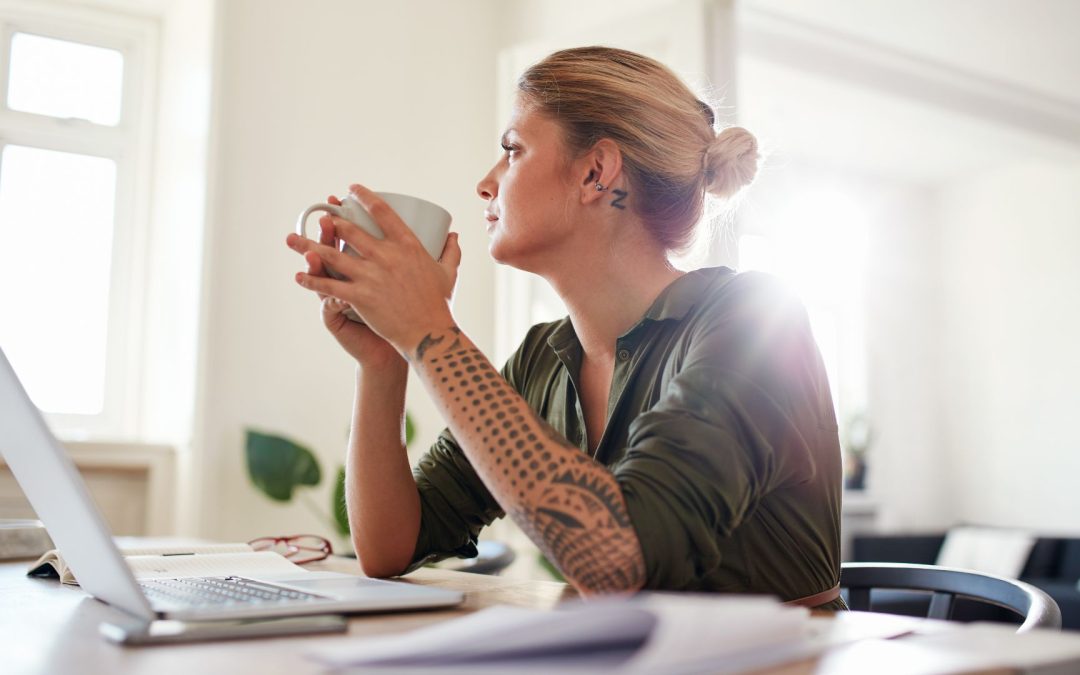 Young Woman with Coffee Looking Away and Thinking