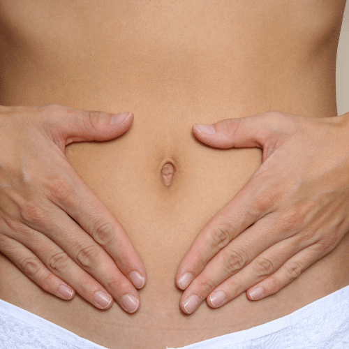 female hands on her abdomen